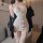 Woman wearing elegant white lace maid costume with corset, garter belt, and thigh-high stockings for role play lingerie.