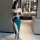 Woman in emerald green lace wrap dress with high slit, backless design, perfect for nightclub or lingerie set.