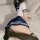 A person wearing a school uniform skirt and thigh-high stockings sits on a bed, showcasing an intimate setting. the scene hig...
