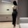 Woman wearing black eruru lace backless split dress, elegant party outfit with crisscross straps and side slit.