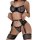Woman modeling black lace mesh lingerie set with sheer bra, thong panty, garter straps, and chain details.