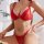 Woman wearing red chain-strap lingerie set, sheer bra and thong bikini, sensual two-piece sleepwear.
