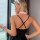 Woman wearing a black european-american style slip dress with sheer maid outfit details, featuring a lace choker and wrist cu...