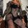 Woman wearing black european-style lace cut-out bodycon mini skirt set with halter backless design, sheer mesh fabric and flo...