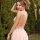 Woman wearing european-style lace sleep dress with halter neck, sheer romantic lingerie set, back view in garden setting.