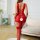 Woman wearing red european-style lacy bodysuit with sheer mesh, cut-outs, and matching stockings in bright living room.