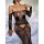 Woman wearing black lace bodysuit with sheer mesh, floral embroidery, and open-crotch thong design on white bed.