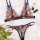 Vibrant floral embroidered lace bra and panty set with purple bows, styled with roses, lipstick, and a heart necklace.