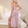A woman poses in a backless, high-slit nightgown with floral patterns and lace trim details, perfect for european-style elega...