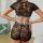 Woman wearing sheer black lace lingerie set with love waistband, featuring floral embroidery and cutout back design.