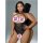 Woman modeling black sheer rose-pattern bodysuit with open-crotch design and halter straps.