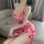 A woman wearing a red floral print nightgown with a deep v-neckline and spaghetti straps, featuring a seductive split design ...