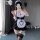 A woman poses in a black and white maid outfit, featuring lace details and stockings, capturing an elegant fantasy cosplay lo...