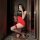 Woman in red and black fei niao kui yue sexy lingerie set, posing with wine glass in mirror selfie.