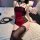 Woman wearing fei niao moon gaze lingerie set - sexy red and black lace bodysuit with adjustable straps, ties, and thigh-high...