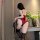 Woman wearing red fei niao moon gaze lace bodysuit with black trim, holding a whip, styled for romantic evenings.