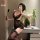 Woman in black lace bodycon dress with floral pattern, holding phone and paddle; feiniao moon gazer sexy lace bodycon dress -...
