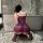 Woman kneeling in bathroom wearing feiniao moon gazer sheer lace camisole and matching briefs, back view with bow detail.