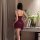 Woman wearing feiniao moonlit lingerie set, a sensual waist-cinching sheer deep v-neck tie-detail sleep dress in burgundy.
