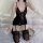 Woman wearing black lace feng qu cat lingerie set with sheer mesh bodysuit, open-crotch design, and suspender stockings on be...