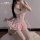 Woman kneeling in pink lace fengqu cat lingerie dress with push-up corset, ruffles, and thigh-high stockings for bedroom play...