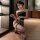 Woman kneeling in black strapless top and flame desire leopard print sheer bustier bodysuit lingerie set.