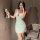 A woman poses with a teddy bear, wearing a light green lace sleepwear set featuring adjustable straps, a bow detail, and remo...