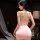 Woman wearing pink bodycon sleep dress with open back and sheer lace details, styled as a seductive secretary nightgown.