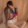 Woman modeling floral lace sailor-style cut-out bodysuit with red bow, designed for role play and intimate wear.