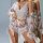 Woman wearing floral lace lingerie set with matching cami, shorts, and robe—romantic sleepwear for at-home elegance.