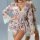 Woman wearing floral lace lingerie set with matching cami, shorts, and robe. romantic sleepwear for at-home comfort.