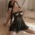 Woman wearing black floral moonlight lingerie set, sheer mesh sleep dress with lace and adjustable straps on bed.