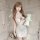 Woman in floral moonlight sensual lace bodycon sleep dress holding plush bunny, elegant bedroom lingerie with red accents.