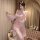 Woman wearing floral moonlight sensual transparent backless chemise with side slit, sheer sleep dress in soft pink tones.