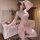 Woman wearing pink floral moonlight sensual transparent backless chemise with side slit, sheer sleeves, and floral print.