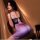 Woman wearing a purple floral seductive lace cheongsam set with deep v neck corset dress, thong, and garter belt.