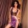 Woman modeling floral lace cheongsam set with deep v corset top, satin mini skirt, thong and garter belt in purple tones.