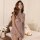 Woman wearing flower moon seduction lingerie set – sheer lace sleepwear with butterfly detail, elegant bedroom scene.