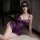 A woman poses in a luxurious purple bodysuit adorned with intricate lace details, featuring an underwire design. the elegant ...