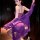 Woman wearing purple french lace lingerie set with sheer slip dress and bodycon fit, posing elegantly in dimly lit room.