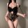 Woman wearing black french lace sheer bodysuit with butterfly knot detail, elegant and alluring design for women.