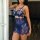 Woman wearing a blue french lace sheer chemise nightgown with intricate floral patterns and a matching thong, showcasing a se...