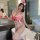 A woman poses in a bathroom wearing a red and white lace nurse bodysuit set, complete with a nurse cap and stethoscope, exudi...