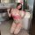 A woman poses in a bathroom wearing a red and white lace nurse bodysuit set, featuring stockings and a cap, exuding a playful...