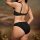 Woman wearing black french-style sheer lace lingerie set, ultra-thin two-piece sensual underwear with delicate straps and ele...