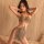 Woman wearing glamorous night lady lace bodysuit set, sheer strap dress with sparkling mesh design for club.