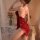 Woman wearing red glorious cloud velvet lingerie set with deep v plunge, criss-cross back, and sheer tease details in romanti...