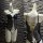 Glowing cloud sexy open-crotch leather bodysuit featuring cross-tie lace design and bell charm, perfect for women seeking ele...