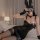 Woman in black pvc bunny outfit with ears, gloves, and choker, posing on bed — glowing cloud sexy bodycon leather skirt set f...