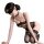 Woman in black lace lingerie set with underwire bra and matching panties, kneeling pose.